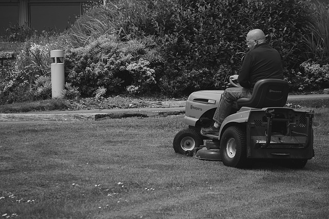 old man on riding lawn mower